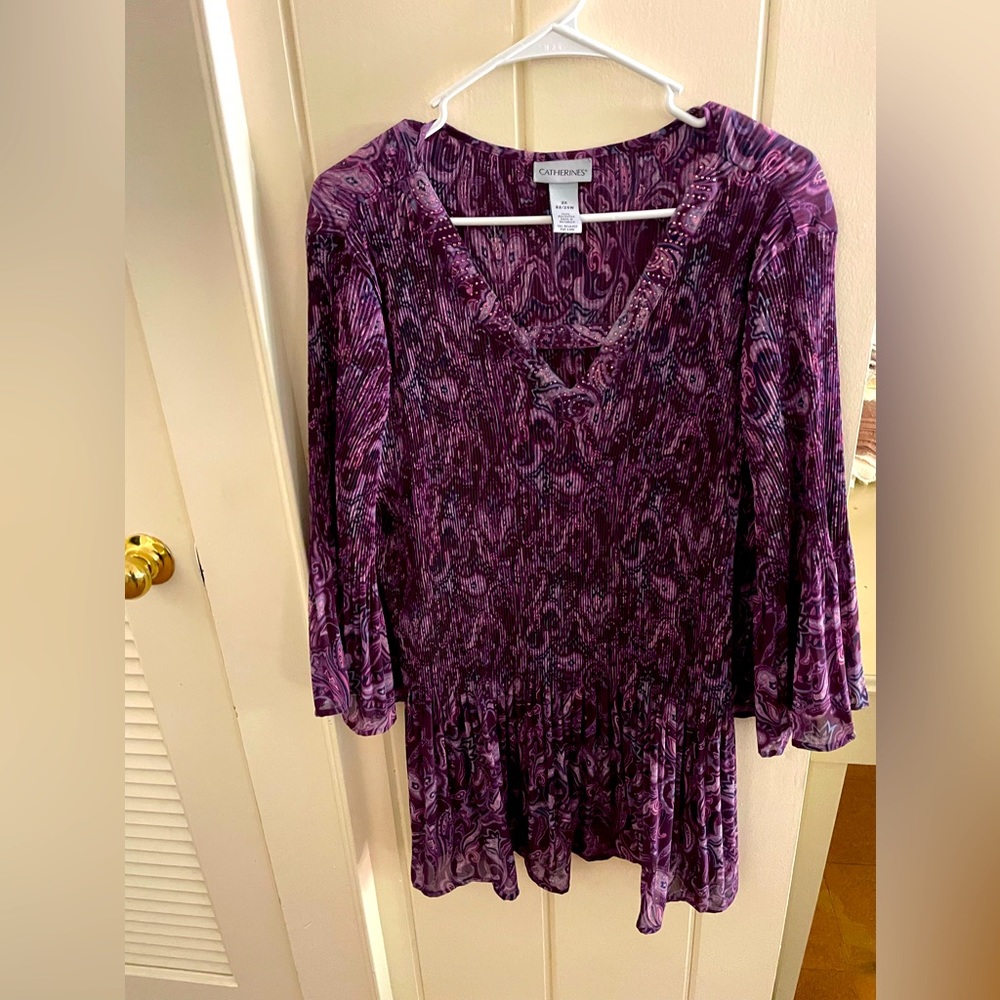 Catherine’s purple paisley bejeweled pleated blouse